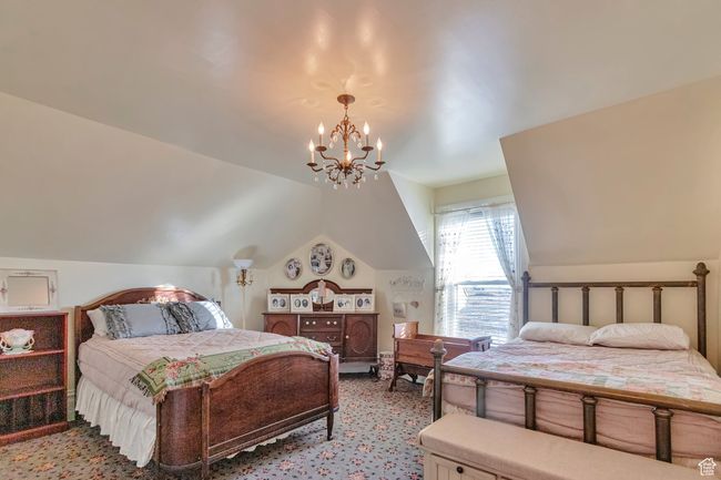 Bedroom with lofted ceiling and a chandelier | Image 31