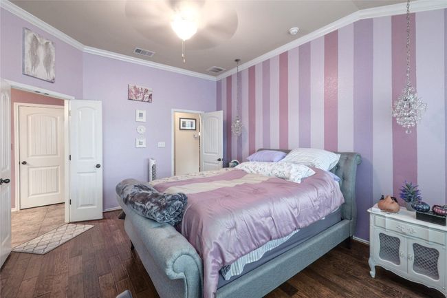 Bedroom featuring ornamental molding, wood finished floors, ceiling fan, and baseboards | Image 15