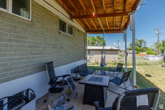 View of patio featuring a fire pit | Image 29