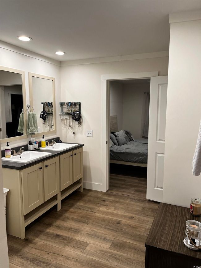 Bathroom featuring double vanity, wood finished floors, recessed lighting, ensuite bathroom, and ornamental molding | Image 19