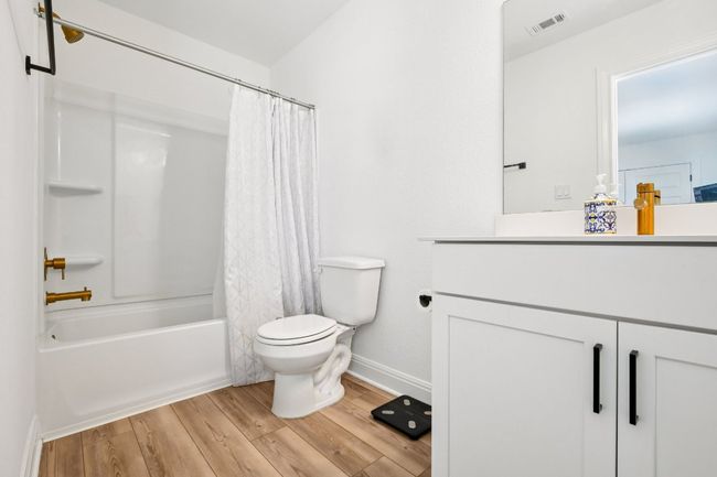 Bathroom with wood finished floors, vanity, and shower / tub combo with curtain | Image 29