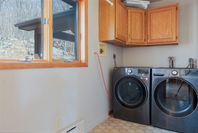Laundry area with washer and clothes dryer, cabinet space, and baseboards | Image 18