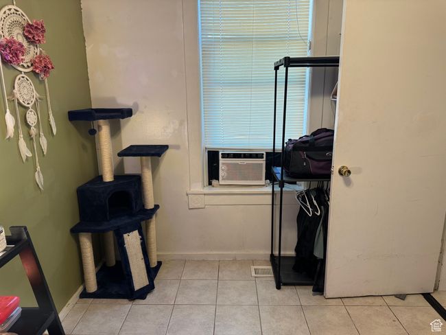 Bathroom with baseboards, visible vents, tile patterned floors, and cooling unit | Image 17