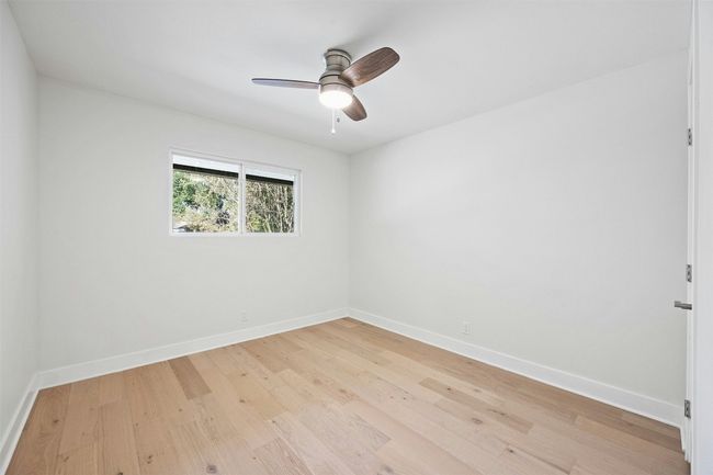 Spare room with light wood-type flooring and ceiling fan | Image 18
