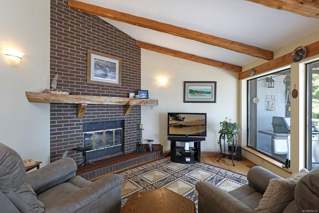 COZY FAMILY ROOM W/FIREPLACE & PATIO DOORS LEADING TO OCEANSIDE DECK | Image 8