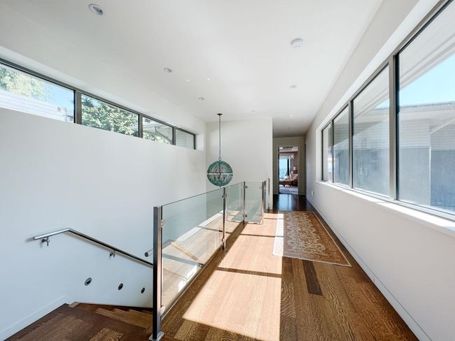Hallway with an upstairs landing, wood finished floors, and baseboards | Image 30
