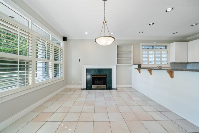 Unfurnished living room featuring recessed lighting, ornamental molding, and a fireplace | Image 10