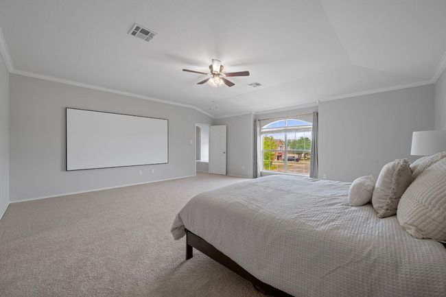 Bedroom featuring carpet flooring, crown molding, baseboards, and a ceiling fan | Image 16