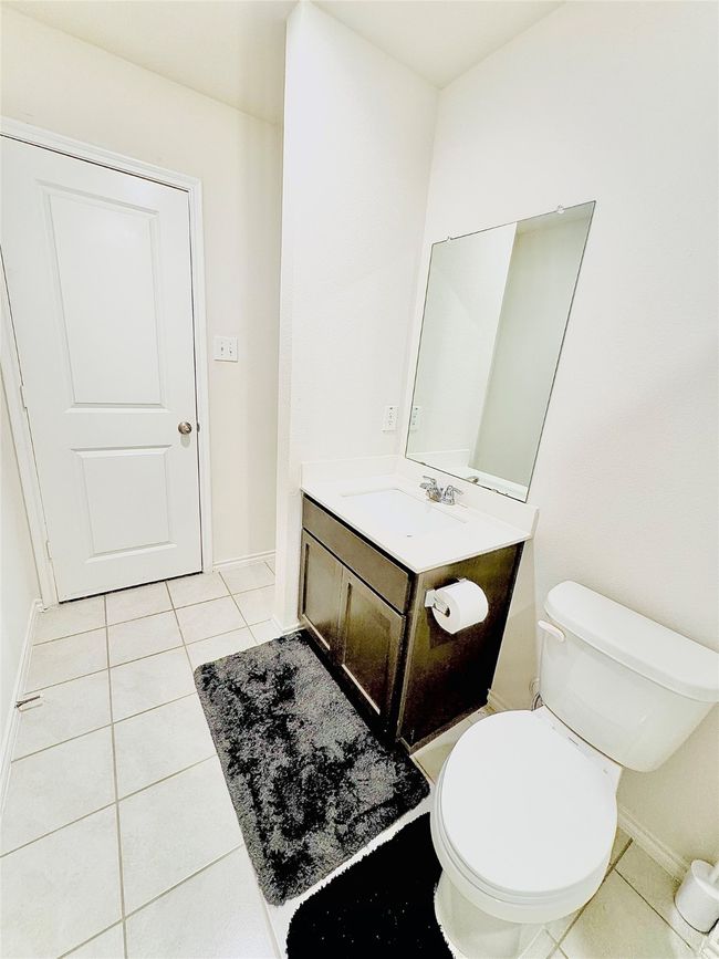 Bathroom featuring tile patterned flooring, vanity, toilet, and baseboards | Image 17