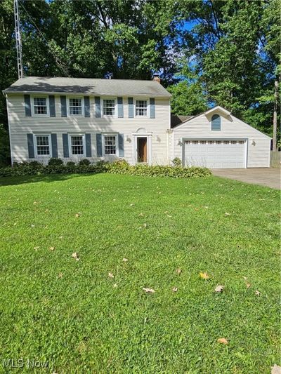 View of front of house featuring a garage and a front yard | Image 1