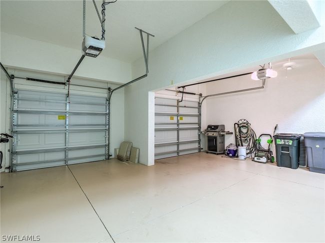 Garage with a garage door opener | Image 34