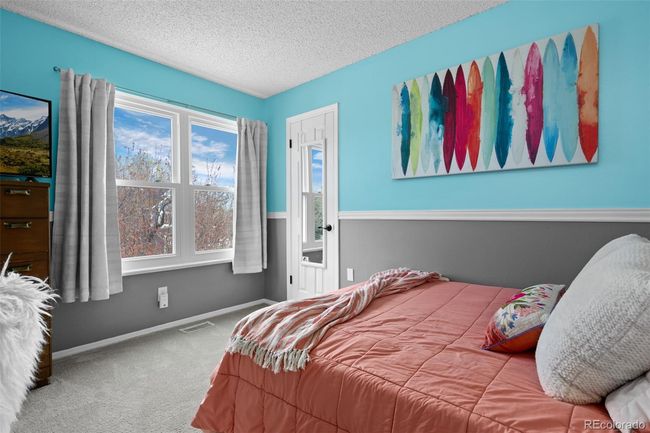 Second bedroom with walk-in closet and large windows. | Image 15