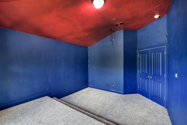 Additional living space with carpet floors, lofted ceiling, and a textured wall | Image 37