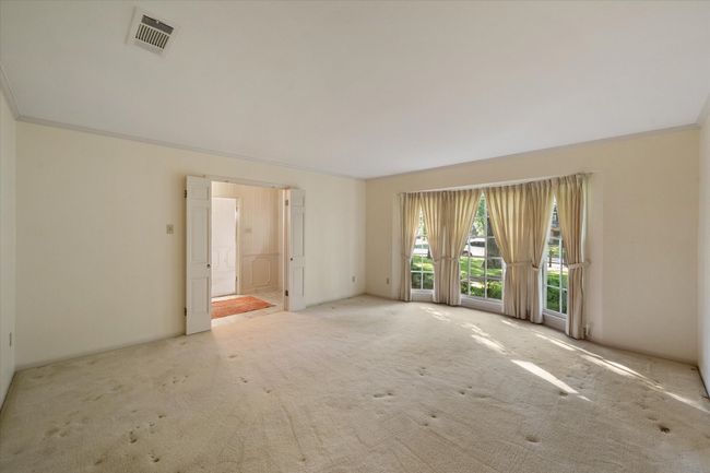 Formal living room with crown molding and wool carpet off of entry hall | Image 19