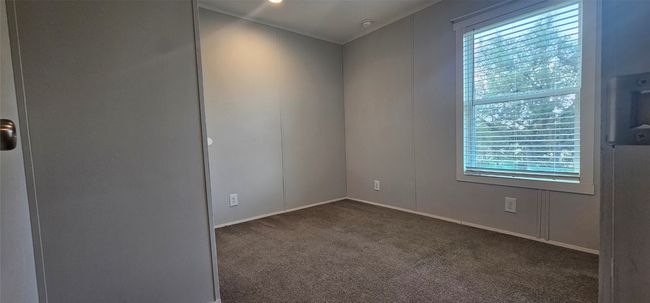 Empty room with dark carpet and plenty of natural light | Image 17