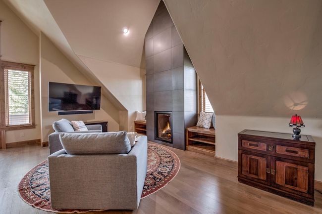 Step into the primary bedroom, with 2 bathrooms, 2 closets, and a sitting area. Enjoy a good book by the beautiful statement fireplace. | Image 16