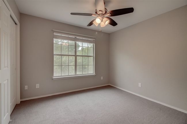 Carpeted spare room featuring a ceiling fan and baseboards | Image 20