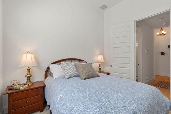 Bedroom with a chandelier and light wood-type flooring | Image 14