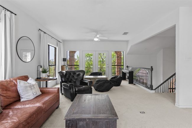 Living area featuring plenty of natural light, a ceiling fan, visible vents, and carpet floors | Image 32