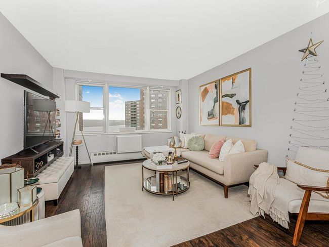 Living area with dark wood-style flooring and a baseboard heating unit | Image 13