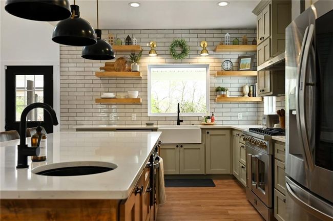 Kitchen featuring appliances with stainless steel finishes, open shelves, a apron farmhouse sink and a prep sink to make cooking so much more efficient. | Image 15