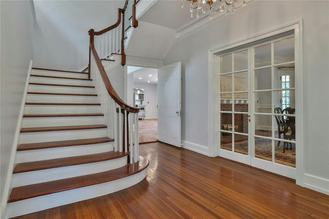 Grand Stairway and crown moldings accentuate the 10' ceiling height, and finished with original hardwood floors | Image 5