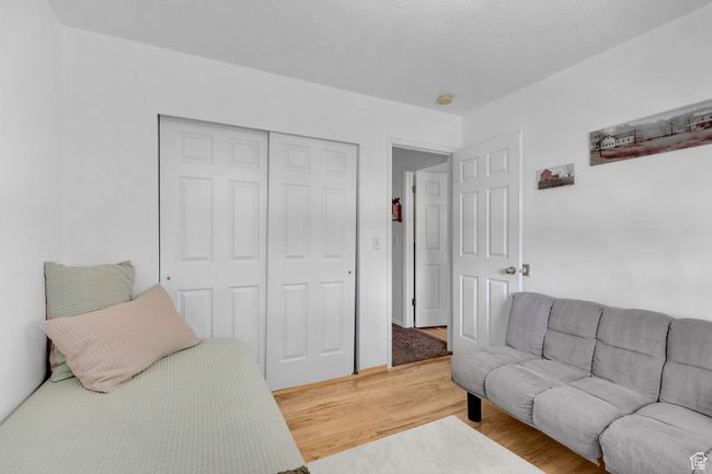 Bedroom featuring a closet and light wood-type flooring | Image 17