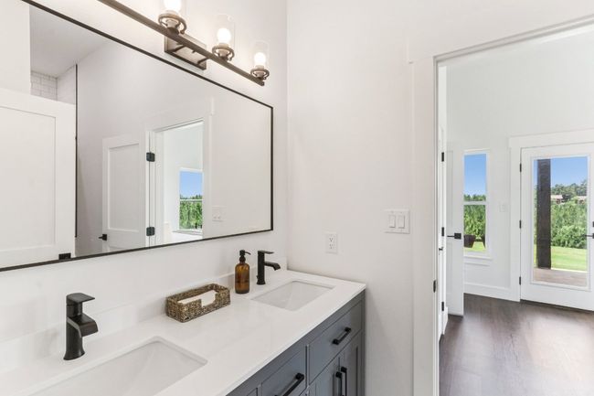 Full bathroom featuring double vanity and wood finished floors | Image 15