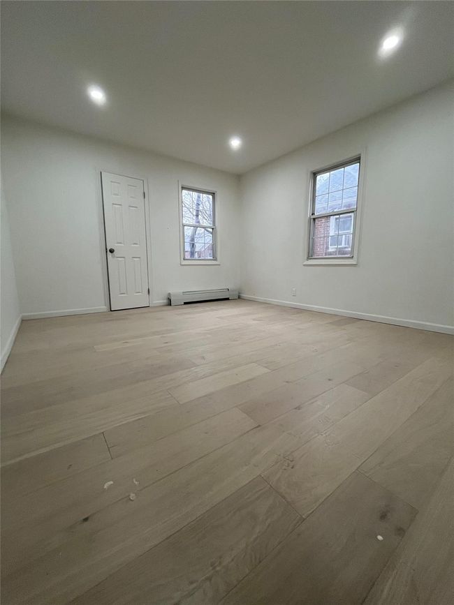 Empty room featuring baseboards, baseboard heating, light wood-style floors, and recessed lighting | Image 4