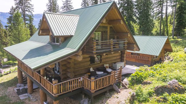 Back of house with log siding, metal roof, and a deck | Image 58