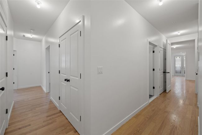 Hallway with light wood finished floors and baseboards | Image 22
