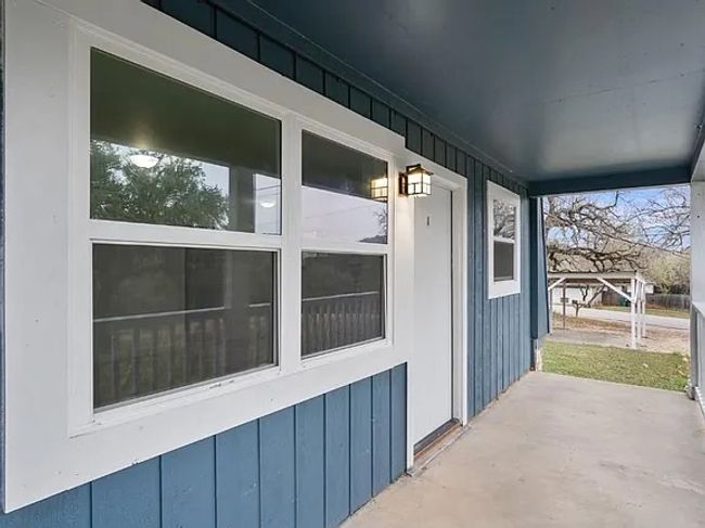 Doorway to property with board and batten siding | Image 11