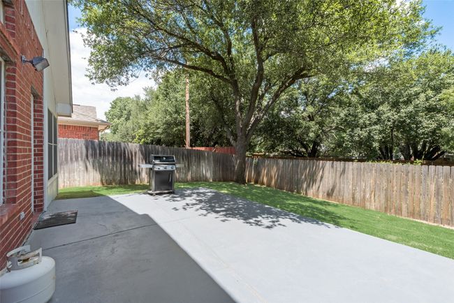 View of patio featuring a grill and a fenced backyard | Image 34