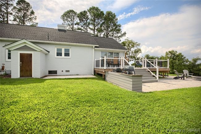 Back of house featuring a patio area, a yard, and a deck | Image 19