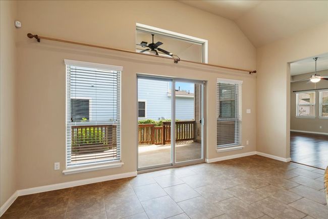The dining area is located by the sliding glass door that leads to the side porch. | Image 20