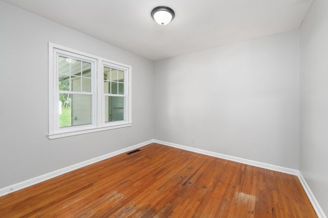 Spare room with baseboards and hardwood / wood-style flooring | Image 20