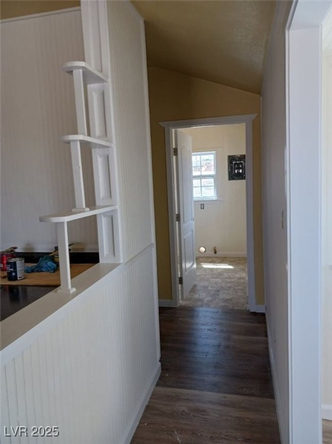 Hallway with wood finished floors, baseboards, and vaulted ceiling | Image 19