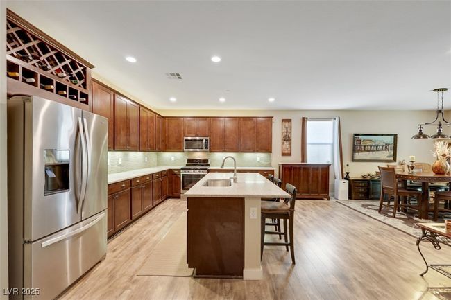 Kitchen featuring a sink, appliances with stainless steel finishes, visible vents, light wood-style floors, and decorative​​‌​​​​‌​​‌‌​‌‌​​​‌‌​​‌‌​‌​​​​​‌ backsplash | Image 15