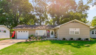 Single story home with a garage and a front lawn | Image 1