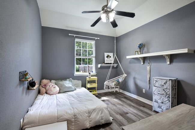 Bedroom featuring wood finished floors and ceiling fan | Image 22