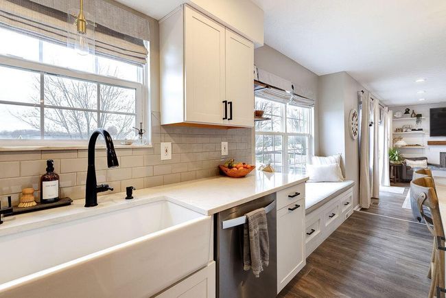 Beutiful Kitchen showcasing large island, subway tile, and apron front sink. | Image 5