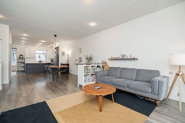 Living room with wood finished floors and baseboards | Image 6