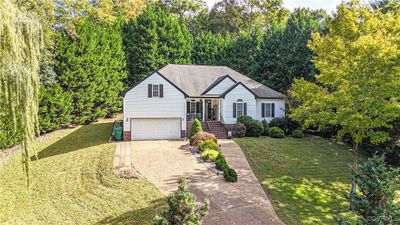 View of front of house with a front yard and a garage | Image 2