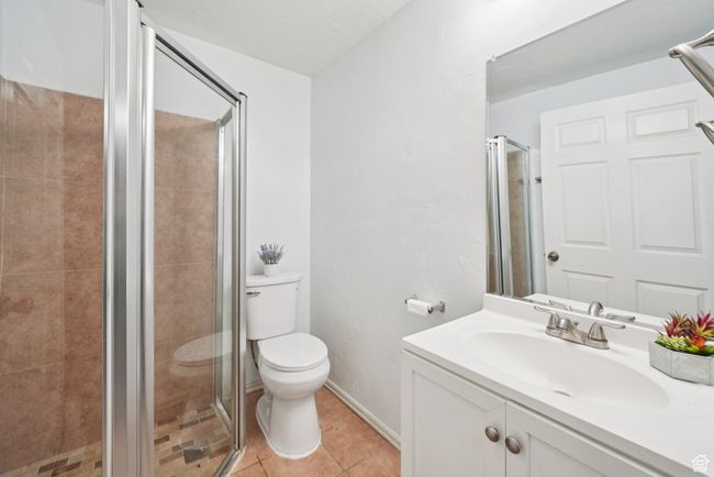Full bathroom with vanity, a stall shower, and tile patterned floors | Image 20