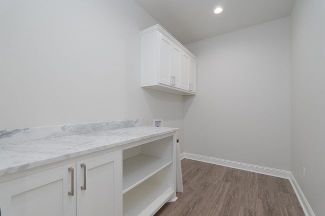 Laundry area with hookup for a washing machine, recessed lighting, baseboards, dark wood-style floors, and cabinet space | Image 32