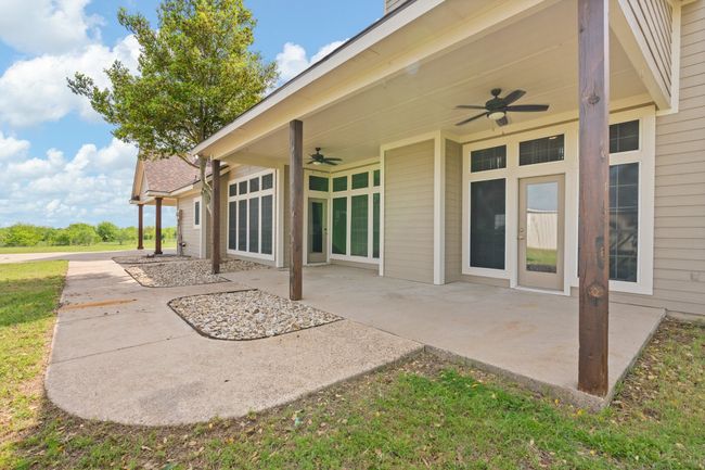 Back covered patio with double ceiling fans. The perfect place to sit in the evening, feel the nice breeze and gaze up at the Texas stars! | Image 38
