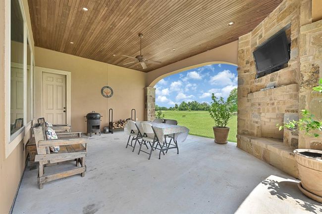 Back covered patio with wood burning fireplace. | Image 45