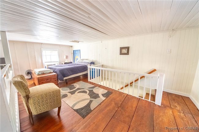 Bedroom with hardwood / wood-style floors and baseboards | Image 26