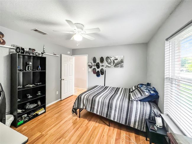 Bedroom featuring wood finished floors and ceiling fan | Image 5