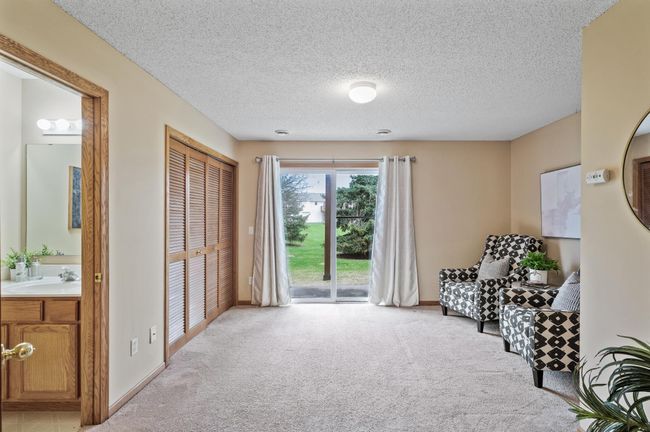 Lower level family room and half bath with walkout to green-space storage under the stairs | Image 15